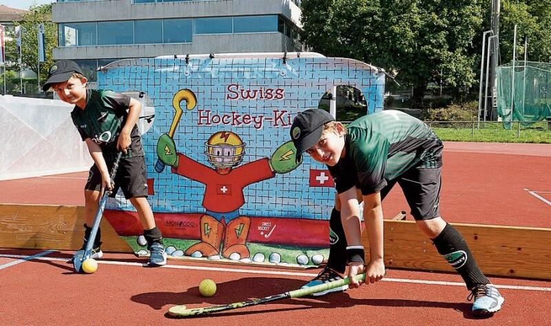 Mats (links) und Finn vom LSC Landhockey zeigten den Kindern auf der Allmend, wie man den Schläger richtig hält.